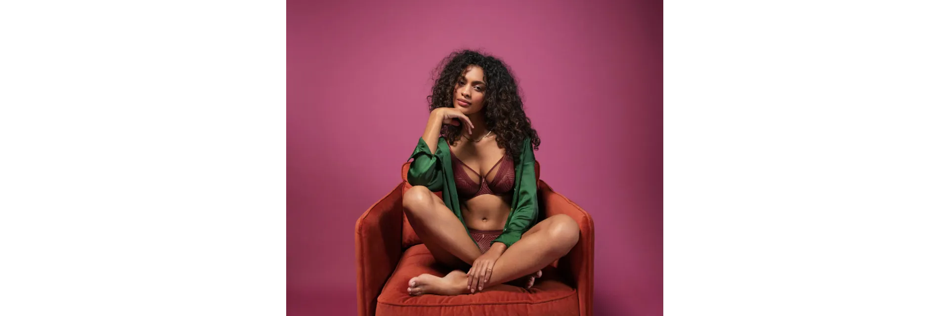 Woman in red chair wearing purple bra