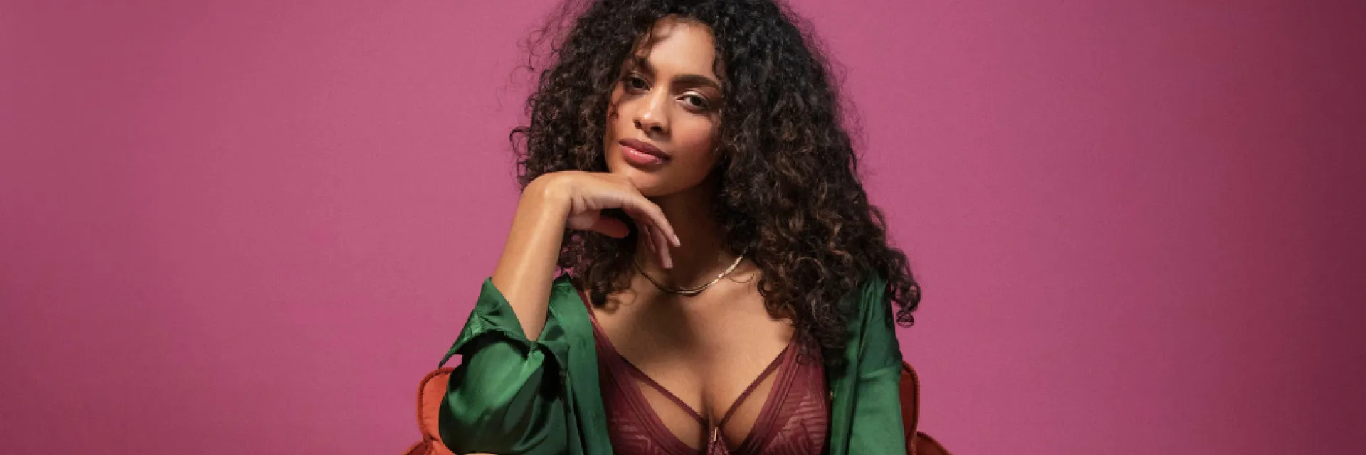 Woman in red chair wearing purple bra